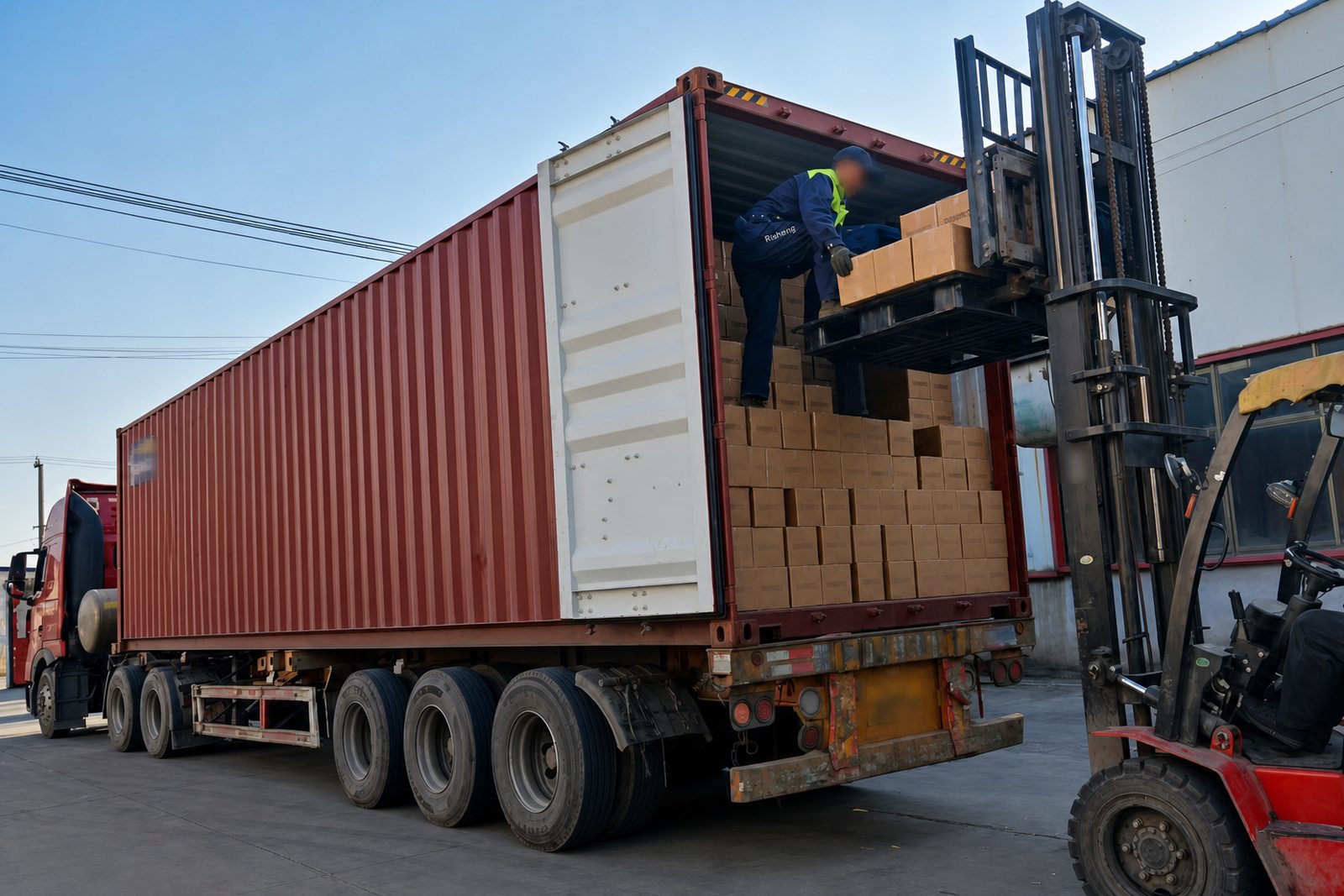 Forklift loading export cartons into a shipping container